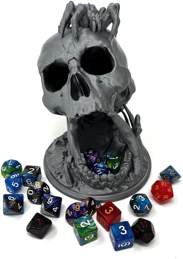 Dice tower shaped like a skull with spiders climbing on it.