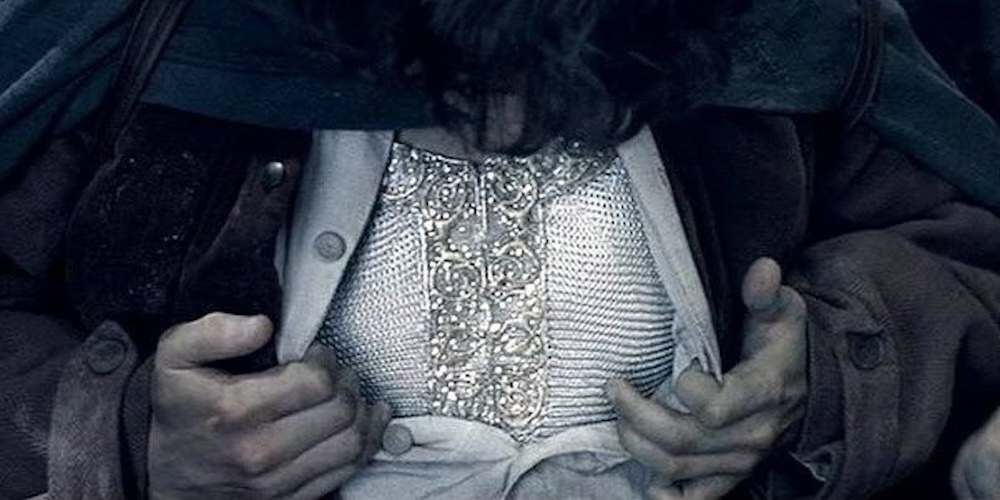 An image of the Hobbit Frodo opening his tunic to reveal a glittering armored shirt made of mithril in Peter Jackson's 'Lord of the Rings'.