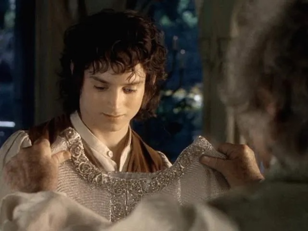 An image of Frodo Baggins admiring a mithril coat being given to him by his uncle Bilbo in Peter Jackson's 'Lord of the Rings' series.